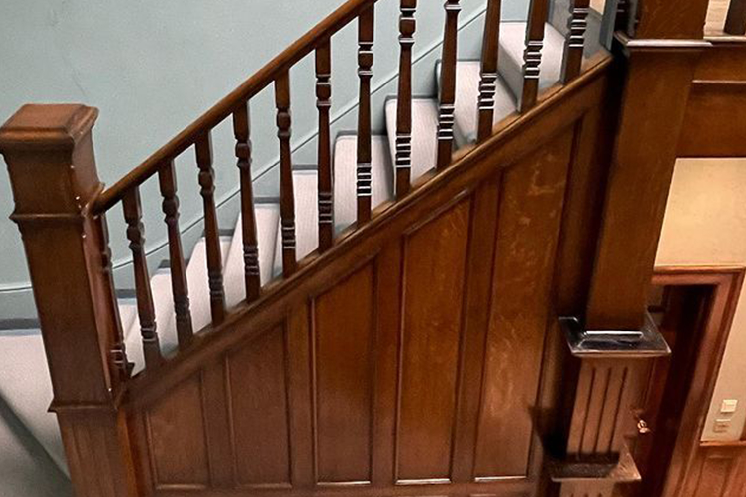 A handrail on a wooden staircase after polishing.