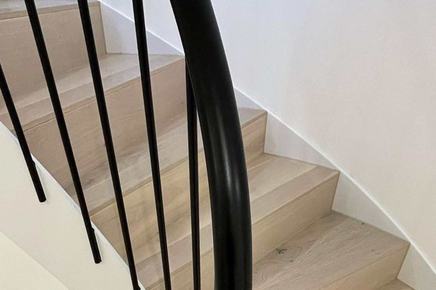 A black rail on a staircase after finishing