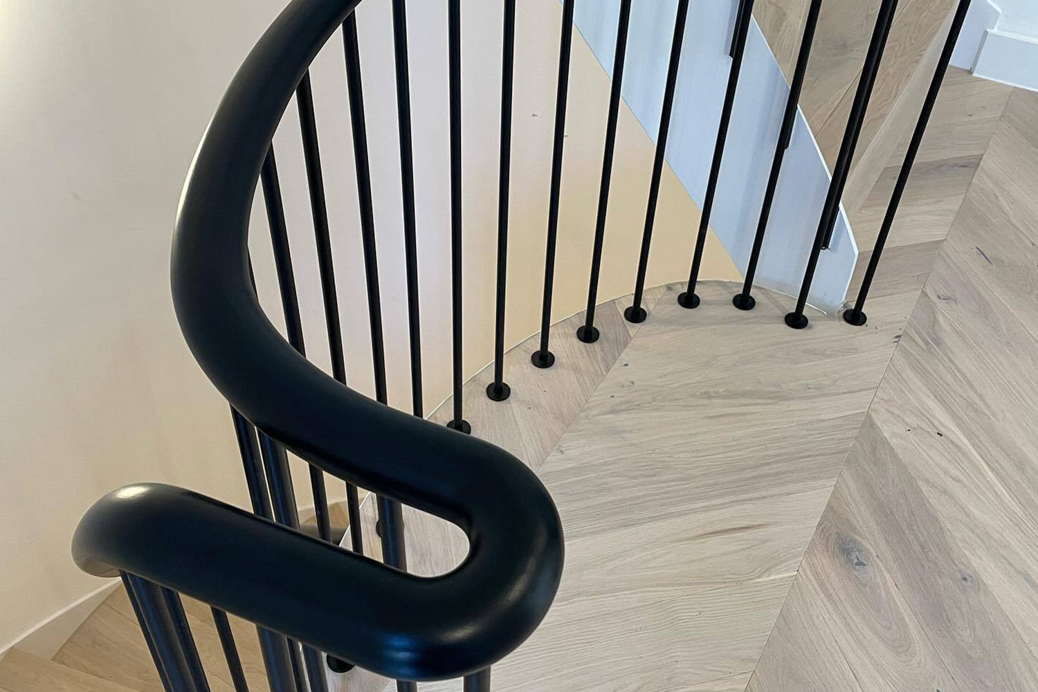 A black handrail on a staircase after finishing