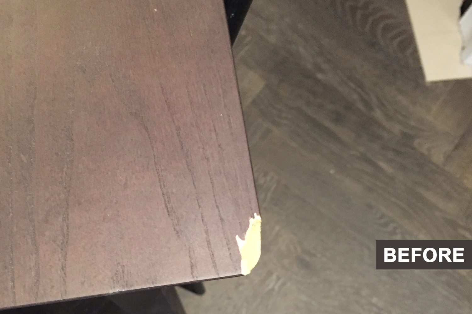A wooden table with a small crack before restoration